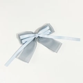 Detail of blue layered mesh and satin bow hair clip with elegant organza texture - Blue