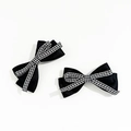 Macro detail of elegant black satin bow hair clips with black and white plaid ribbon layer - Black