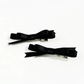 Detailed close-up of two black silk bow hair clips with silver alligator metal grips - Black