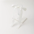 Detalle de lazo de encaje blanco en vidrio con relieve y estilo de estética minimalista - Beige