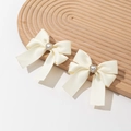 Fermaglio per capelli con fiocco in raso crema e cuore di perle su vassoio decorativo in legno - Beige