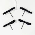 Detailed macro view of four black satin bow hair clips on minimalist metal snap barrettes - Black Satin Ribbon Style / Black