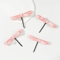 Set of four pink satin bow hair clips with black metal pins on a white decorative plate - Pink Satin Style / Pink