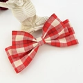 Detail of red and white checkered bow hair clip with textured cotton linen fabric - Red