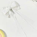 Detailed view of the elegant white lace and satin ribbon bow hair clip with long streamers - White (Long)