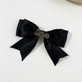Detail of black satin bow hair clip with a rhinestone Love metal plate decoration - Black