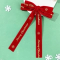 Detail of red velvet Christmas bow with gold Merry Christmas lettering and stars - Hair Clip Style / Red
