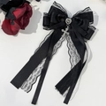 Detail of gothic black satin bow with lace, heart gemstone, and silver cross pendant - Black Cross Pendant Style