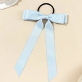 Detail of light blue ribbon bow hair tie with elegant long streamers and satin texture - Blue