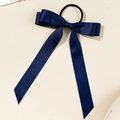 Detail of long dark blue satin ribbon bow hair tie on a minimalist cream background - Navy Blue