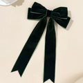 Close-up of dark green velvet bow hair clip with long ribbons and swallowtail ends - Dark Green
