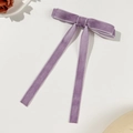 Detail of lavender velvet ribbon bow hair clip with long streamers on elegant background - Purple