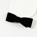 Detail of a soft black plush bow hair clip featuring a white elastic band for hair styling - Black