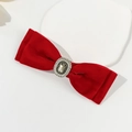 Detailed view of red velvet bow hair clip with pearl and rhinestone centerpiece - Red