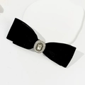 Detail of black velvet bow clip with vintage pearl and rhinestone center ornament - Black