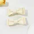 Close-up of cream corduroy bow hair clips with soft ribbed texture and elegant style - Beige