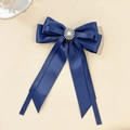 Close-up of navy blue satin layered bow hair clip with luxury rhinestone centerpiece - Navy Blue
