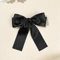 Close-up of black satin bow hair clip showing smooth silk texture and double layer detail - Black