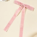 Close-up of pink velvet bow hair clip with white pearls and elegant long ribbons - Pink