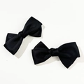 Close-up of a pair of black ribbon bow hair clips with a detailed twill fabric texture - Black