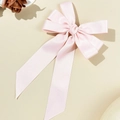 Detail of light pink satin bow hair clip featuring soft ribbon texture and long streamers - Double Layer Bow Streamer Style / Pink