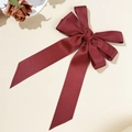 Macro shot of elegant deep wine red satin bow hair clip with flowing ribbon tails - Double Layer Bow Streamer Style / Burgundy