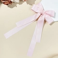 Elegant light pink satin bow hair clip with long ribbons on a decorative white plate - Pink