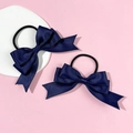 Detail of navy blue ribbon bow hair ties with textured fabric on a pink background - Navy Blue (Pair)