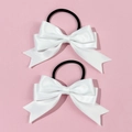 Detailed close-up of white satin bow hair tie with elastic band on pink background - White (Pair)