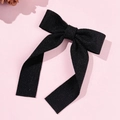 Close-up of elegant black ribbon bow hair clip with ribbed texture and long streamers - Black