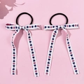 Detail of embroidered heart and flower patterns on bow hair ties with long streamers - Style 2 Navy Heart Pink Floral