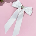 Detail of white satin bow hair clip with heart pearl center and vintage gold trim - White