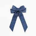 Detail of blue denim bow hair clip with silver polka dots and long trailing ribbons - Dark Blue Denim