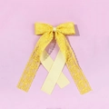 Detail of yellow lace bow hair clip with elegant floral texture and long silk streamers - Yellow