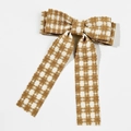Detail van de tweed haarklem met pied-de-poule strik en elegante bruin-witte linten - Beige