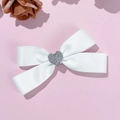 Elegant white satin bow hair clip with a sparkling silver rhinestone heart centerpiece - White