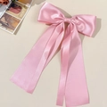 Pink satin oversized bow hair clip with long ribbons on an elegant beige background - Pink