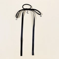 Detail of black velvet hair tie with silver star and moon charms on long ribbons - Black