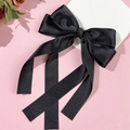 Elegant black satin bow hair clip with long ribbons on pink decorative background - Black