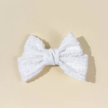 Detailed macro view of the intricate white crochet lace floral texture on the hair clip bow - White
