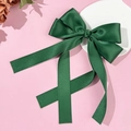 Close-up of a deep green satin bow hair clip with elegant long ribbons on pink background - Dark Green