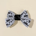 Detailed view of handmade lace bow hair clip featuring elegant black ribbon and white embroidery - Black