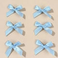 Set of six light blue satin bow hair clips featuring a glossy finish and metal base pins - Blue