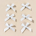 Detailed view of six white satin bow hair clips arranged neatly in a minimalist 2x3 layout - White