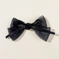 Détail d'un nœud en résille noire orné de paillettes argentées au style élégant - Noir