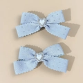 Detail of light blue bow hair clips featuring scalloped edges and sparkling heart rhinestones - Light Blue