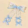 Close-up of white lace hair clip featuring elegant light blue satin ribbon bows - Blue