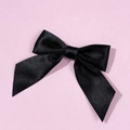 Detail of elegant black satin bow tie with smooth texture and classic ribbon tails - Black