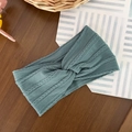 Detailed knit texture of light blue baby headband with a twisted knot on wood - Dark Blue