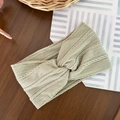 Close-up of sage green cable knit elastic baby headband with a cross knot design - Olive Green
